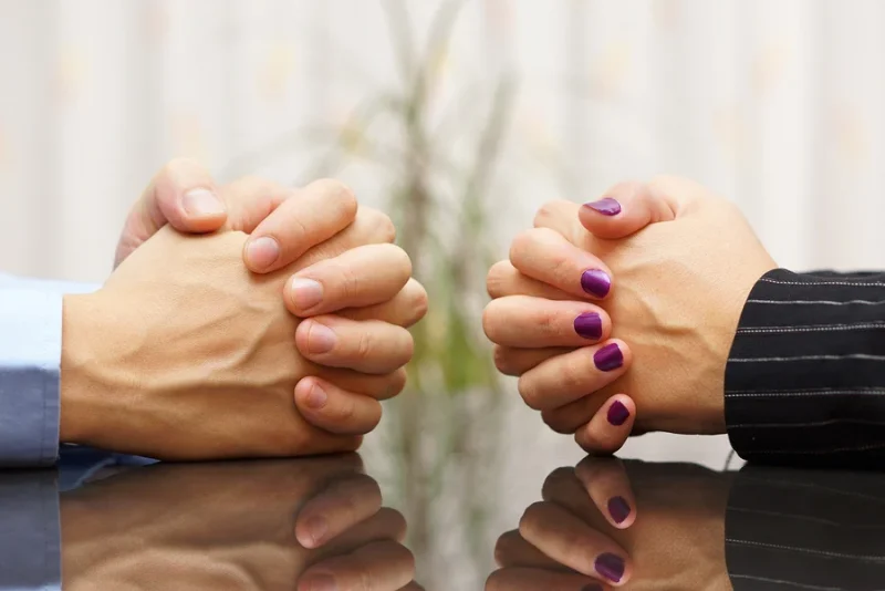 Family law hands with interlocked fingers